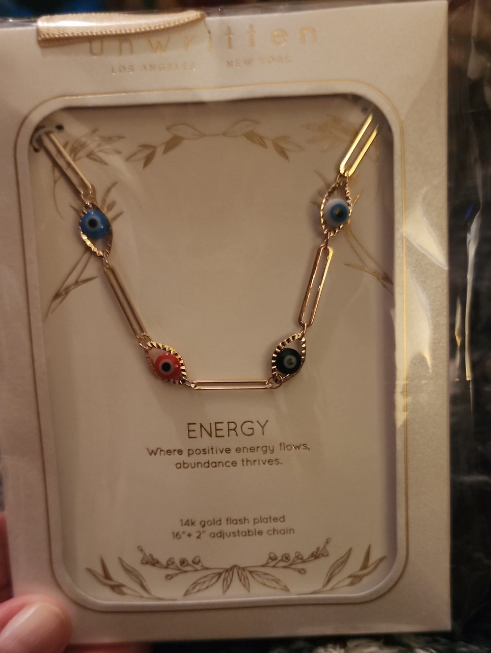 Unwritten Gold-Tone Necklace with Blue, Red, and Black Eye Charms